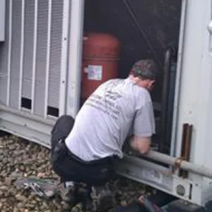 A man working on the side of a building.